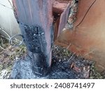Small photo of Inspection hatch in the chimney for its cleaning. A thick metal pipe that acts as a chimney on the street near the wall. House heating system. A charred chimney pipe.