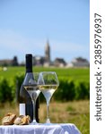 Small photo of Glasses of white wine from vineyards of Pouilly-Fume appelation and example of flint pebbles soil, near Pouilly-sur-Loire, Burgundy, France.