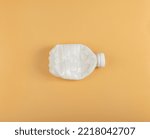 Empty Plastic Milk Bottle Isolated, Crumpled Plastic Bottle, Global Pollution Concept, Squashed Pet Bottles on Yellow Background