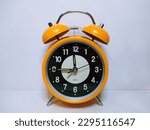 Small photo of A clock is very useful thing for life. We measure time with it. The color of this clock is more than enough alive. People like it. How like an orange,maybe!