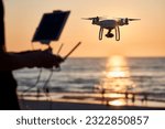 Drone operated by young man flying over an sea