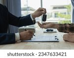 Small photo of Company employees are handing out car keys to tenants after discussing the details and rental terms along with the tenant who signed the contract.