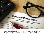 Small photo of Purchase requisition, pen, calculator and glasses on desk
