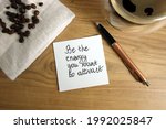 Be the energy you want to attract text handwritten on sticky note with coffee and pen, law of attraction concept