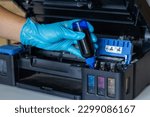 Small photo of Technicians Refill ink cartridges, printer Inkjet colors.Printer Repairs and Maintenance inkjet or Laser printers concept ,selective focus