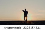 Small photo of Agronomist silhouette examines height and structure of seedlings at sunrise. Farmer reviews sprouts to gauge robustness in morning. Agronomist in cap conducts thorough evaluation of soil and plants