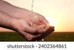 Small photo of man washes hands sunset, taking care hygiene cleanliness. people strive ensure purity protection. Water washing important resource. Washing your hands sunset strives purity freedom. importance