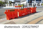 Small photo of Pacitan, Indonesia - September 17, 2023: Road blockers or plastic crash barriers or water filled barriers or traffic barrier image in the side of pedestrian area