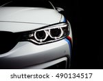 New aggressive headlight by night. Car details. The front lights of the sports car. Car's light. Insurance concept
