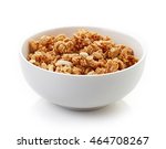 Bowl of whole grain muesli isolated on white background