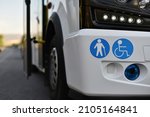 stickers of places for a disabled person and elderly on body of small shuttle bus