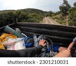 Backpackers also hitchhikers behind a tractor travelling inside a forest.(I have removed the brand names on bags now it's clear)