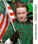 Small photo of Teen Female Marches With St. paddys Flag In St. Patric's Day Parade . Created 09.27.2023