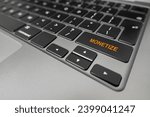Small photo of Monetize written on laptop keyboard extreme closeup
