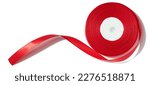 Small photo of A spool with a red silk ribbon on a white isolated background, an object for decoration