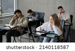 Small photo of Young students employees workers unmotivated staff sitting in classroom listening boring lecture tedious coach teacher at corporate seminar bored participants fall asleep overloaded with information
