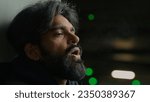Small photo of Helpless homeless Indian depressed stressed bearded man suffer at dark parking lot city night froze Arabian stressful grief sad upset guy exhale steam frozen breath frosty smoke cold temperature flue
