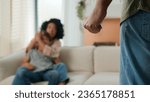 Small photo of Domestic violence physical abuse in multiracial family scared woman in fear protecting little boy child son from cruel aggressive man clench fist back view threaten to beat home conflict attack crime