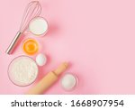 Frame of food ingredients for baking on a gently pink pastel background. Cooking flat lay with copy space. Top view. Baking concept. 