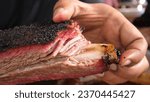 Small photo of A big juicy Barbecue beef ribs - BBQ beef rib with barbecue in hand beef ribs, spicy, hot, grilled, BBQ, big, juicy, smoked, meaty, BBQs beef rib, baked, brisket, dark crust, classic Texas barbecue