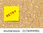 Small photo of Yellow note paper with word retry on cork board background with copy space