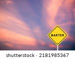 Small photo of Yellow transportation sign with word barter on violet sky background