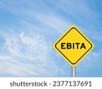 Small photo of Yellow transportation sign with word EBITA (abbreviation of earnings before interest, taxes and amortization) on blue color sky background