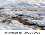 Pools of tundra water just beginning to freeze for the winter in the Alaskan Arctic in a valley in the Brooks Range
