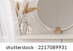 3D render close up blank empty space on modern beige dressing table with round mirror, decor dried pampas grass with blowing white sheer curtains, morning sunlight, foliages. Kbeauty products display.