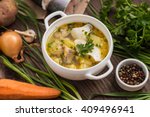 Fresh fish soup with ingredients and spices for cooking. Wooden background 