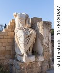 Small photo of Caesarea, Israel, November 30, 2019 : Seated statue with broken arms and head made of white marble in Caesarea Fortress on the Mediterranean coast near Caesarea city in northern Israel