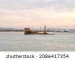 Small photo of Acre, Israel, December 04, 2021 : Remains of the fortress wall with a lighthouse will be found in the gulf of the Mediterranean Sea, outside the city walls of Acre old city, in northern Israel