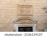 Small photo of Nazareth, Israel, February 12, 2022 : Religious symbols carved in stone above the entrance to the Maronite church of St. Antonius in old part of Nazareth, northern Israel