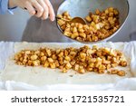 
Cooking apple strudel. Girl is preparing a pie at home in an apron. Work with puff pastry. The process of making apple strudel. Rash fillings in puff pastry.apples are placed in the dough.Summer