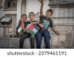 Small photo of Tunis, Tunis - October 19 2023: The young boys with Palestine flags at the pro-Palestine and anti-Israel protest rally at Tunis, Tunisia, after the hospital blast in Gaza strip.