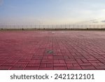 Small photo of Helicopter pad. A red landing area for helicopters at sunset. Helipad landing lights. Illumination equipment for helicopter landing pads.