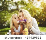 Mother and daughter family time, blowing bubbles