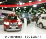 Blurred image of people in cars exhibition show