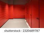Small photo of an empty public toiled with red tiles