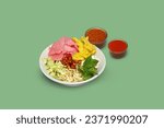Small photo of Asinan Betawi Set, complete with peanut sauce and chili sauce, in clean Chatty Cricket color background, high angle view