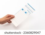 Small photo of Hand holding a time card. Translation:Time card, name, year, month, affiliation, date, regular hours, attendance, leaving work, within hours, after hours, subtotal