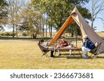 A family enjoying camping on a...