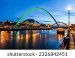 Newcastle and Gateshead at sundown showing Gateshead Millennium Bridge , sage and Tyne Bridges.