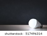 LED light bulb on table with black background