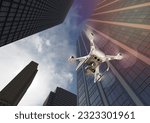 Unmanned Aircraft System Quadcopter Drone In The Air Among the City and Corporate Buildings.