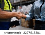 Small photo of Warehouse manager handshake together with business partner, supplier, investment trust honesty team to supply product, delivery shipment to factory for logistic distribution. Inventory, store, storage