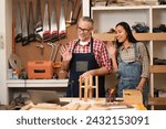 Furniture business owner wave greetings to customers during online live to promote the woodcraft product. Senior Carpenter with wife conducted the furniture online website to expand sales channel