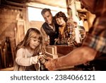 Small photo of Father continues the legacy with his children in grandfather carpenter shop