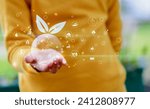 Small photo of girlie Hand holding green leaf with icons energy sources for renewable, sustainable development. Ecology concept.