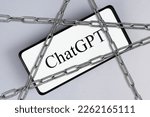Small photo of ChatGPT and block, cancel, ban concept. ChatGPT chat bot with artificial intelligence on mobile phone screen and steel chains, symbol of prohibition, cancellation. Astana, Kazakhstan 14.02.2023.